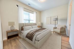 Columbus apartment for rent - A bedroom with a large bed and a chair.