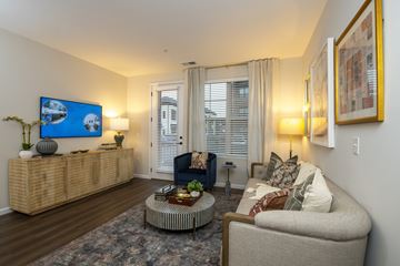 Westerville apartment for rent - A living room with a sofa, a coffee table, and a painting on the wall.