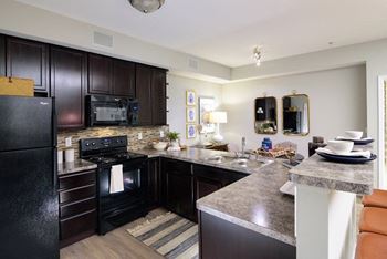 A kitchen with a stove top oven next to a sink