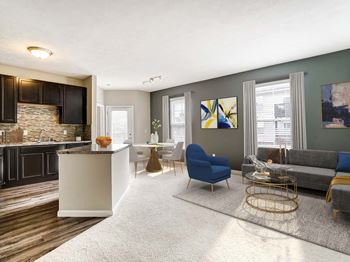 A living room with a kitchen in the background