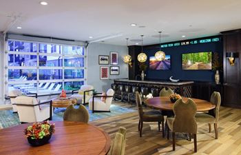 A room with a large window and a table with chairs
