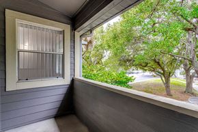 Melbourne apartment for rent - a balcony with a view of trees and a street