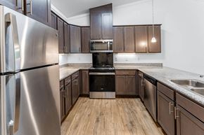 Summerville apartment for rent - A kitchen with a stainless steel refrigerator and wooden floors.