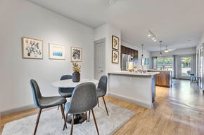 Round Rock apartment for rent - a dining area with a round table and chairs and a kitchen with a sink