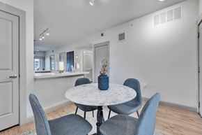 Round Rock apartment for rent - a dining room with a marble table and blue chairs