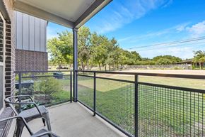 Round Rock apartment for rent - the preserve at ballantyne commons balcony and yard with grass and trees