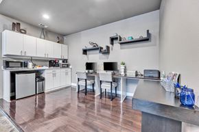 San Antonio apartment for rent - a kitchen with white cabinets and stainless steel appliances and a table with chairs at Waters at Elm Creek, San Antonio, Texas
