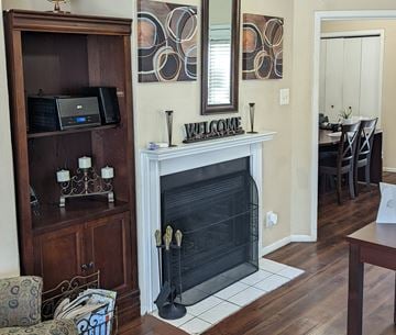 Dallas apartment for rent - a living room with a fireplace and a mirror on the wall