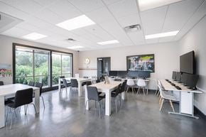 Austin apartment for rent - a dining room with tables and chairs and a tv