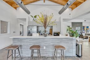 Savannah apartment for rent - A modern kitchen with a stone counter and bar stools.