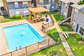 Mckinney apartment for rent - an aerial view of a swimming pool and a picnic table in front of a house