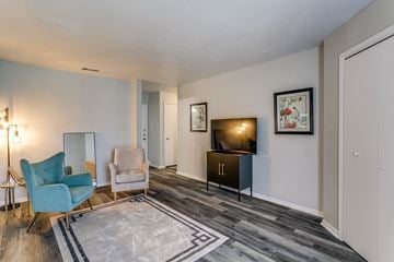 Lewisville apartment for rent - the living room of an apartment with a couch and chairs and a tv