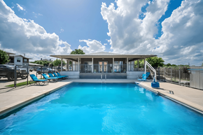 Austin apartment for rent - A large swimming pool with a building in the background.
