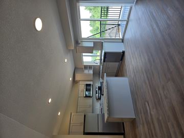 Aitkin apartment for rent - A modern kitchen with wooden floors and white walls.