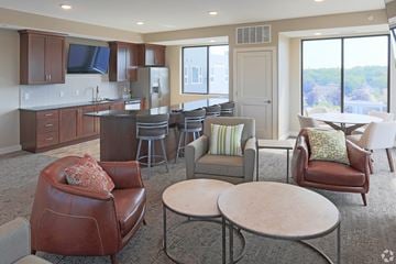 Owatonna apartment for rent - A living room with a brown leather chair and a white table.