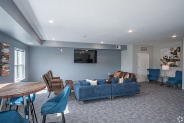 Dodge Center apartment for rent - a living room with a blue couch and chairs and a table