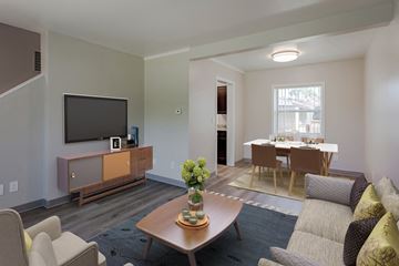 Rochester townhouse for rent - a living room with a couch and a table and a television