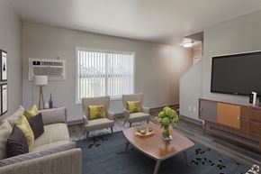 Rochester townhouse for rent - a living room with couches and chairs and a television