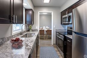Rochester townhouse for rent - a kitchen with granite counter tops and stainless steel appliances