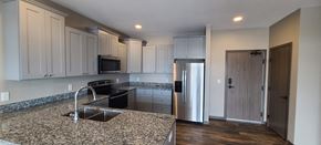 Melrose apartment for rent - a kitchen with granite counter tops and white cabinets