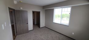 Melrose apartment for rent - an empty living room with a window and a door