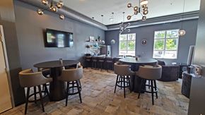 Lino Lakes apartment for rent - a dining room with tables and chairs and a tv in the corner