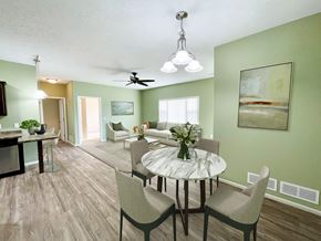 Sartell townhouse for rent - a living room and dining room with a table and chairs