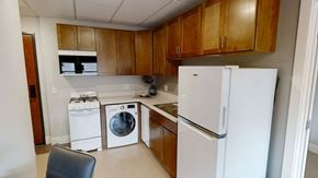 Duluth apartment for rent - a kitchen with white appliances and wooden cabinets