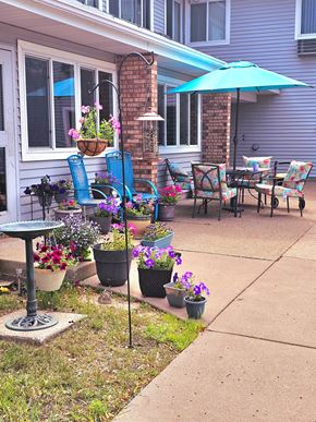 Big Lake apartment for rent - a patio with chairs and umbrellas and pots of flowers