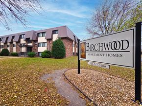St Cloud apartment for rent - A sign for Birchwood Apartment Homes stands in front of a building.