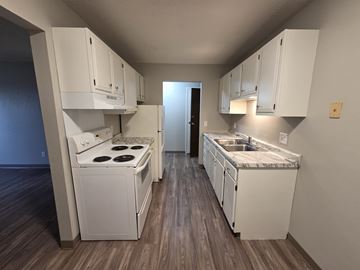 St Cloud apartment for rent - A kitchen with white cabinets and a stove top oven.
