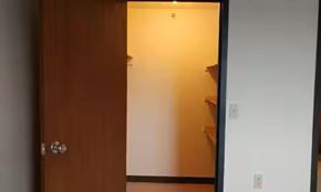 Anoka apartment for rent - A white door is open to a room with a wooden door.