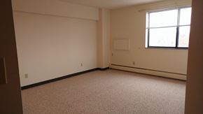 Anoka apartment for rent - A room with a carpeted floor and a window.