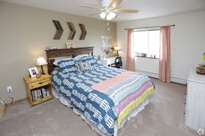Alexandria apartment for rent - A bedroom with a bed, nightstand, and window.