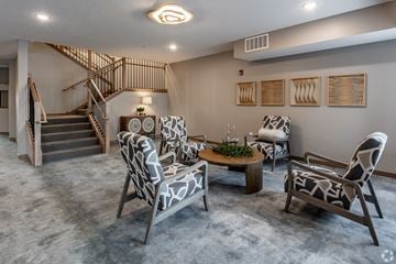 Alexandria apartment for rent - A living room with a grey carpet and a wooden staircase.