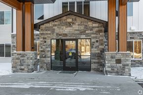 Alexandria apartment for rent - A building with a stone facade and a black door.