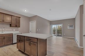 Little Falls apartment for rent - A kitchen with wooden cabinets and a white countertop.