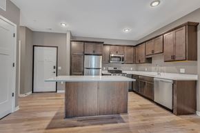 Little Falls apartment for rent - A modern kitchen with wooden cabinets and a central island.