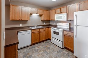 St Augusta apartment for rent - a kitchen with white appliances and wooden cabinets