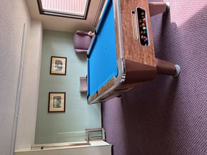 Brainerd apartment for rent - A pool table with a brown side rail and a blue felt cloth.