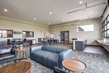 Coon Rapids apartment for rent - a living room with a couch and tables and a kitchen
