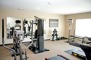 Gaylord apartment for rent - A gym with a mirror, weights, and cardio equipment.