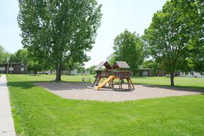 Little Falls townhouse for rent - A playground with a yellow slide and a brown wooden structure.