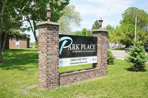 Little Falls townhouse for rent - A sign for Park Place Apartments and Townhomes is displayed in front of a grassy area.