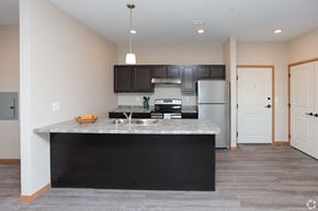 East Bethel apartment for rent - A kitchen with a black countertop and stainless steel appliances.