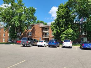 Hawley apartment for rent - A parking lot with cars and a building in the background.