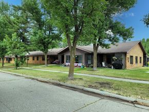 Twin Valley apartment for rent - A tree in front of a house with a lawn chair and a grill on the lawn.