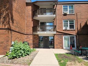 Hawley apartment for rent - A brick building with a balcony and a small garden in front.