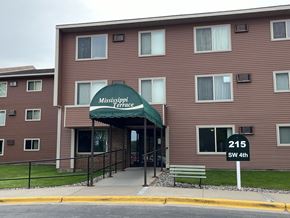 Brainerd apartment for rent - The front of the Mississippi Terrace apartment building with a green awning.