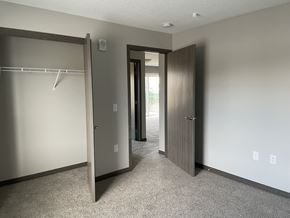 Sleepy Eye apartment for rent - an empty bedroom with a closet and two doors